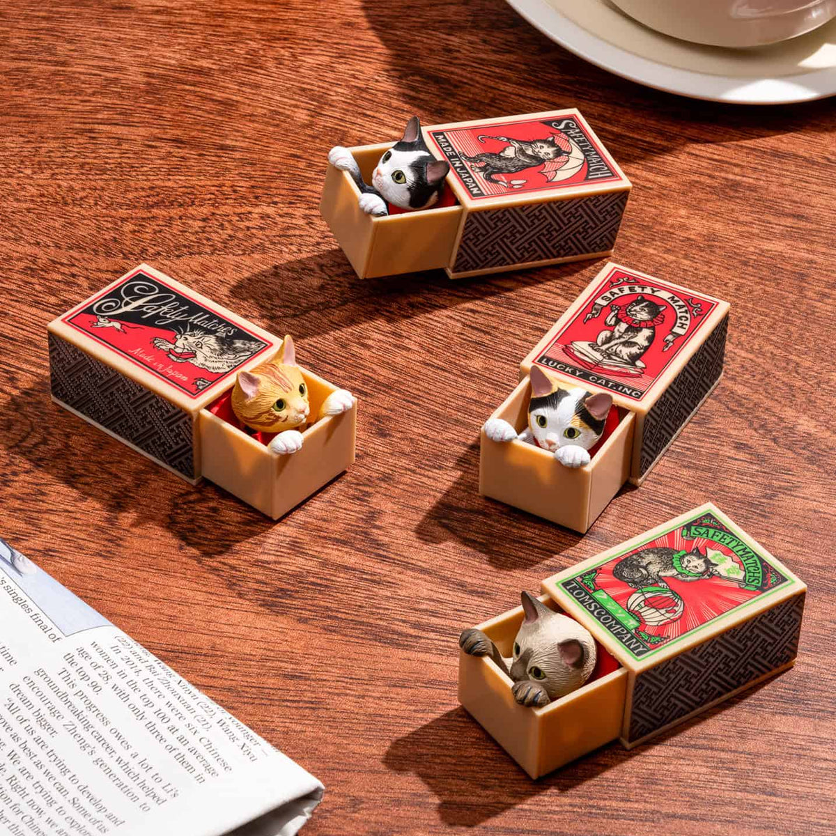 Cat Peek Matchbox miniature cat figures displayed in vintage-style matchboxes
