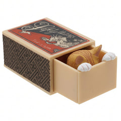 Orange tabby cat hiding inside its miniature matchbox
