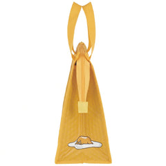 Side of the yellow Gudetama Face lunch bag with carry handles, zipper, and fried egg artwork